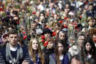 Catholic worshippers take part in a Palm Sunday pilgrimage in Bucharest April 13, 2014. Palm Sunday commemorates Jesus Christ's triumphant entry into Jerusalem, before he was crucified. Catholic believers celebrate Easter on April 20, together with Romania's Christian Orthodox majority. REUTERS/Bogdan Cristel (ROMANIA - Tags: RELIGION SOCIETY)