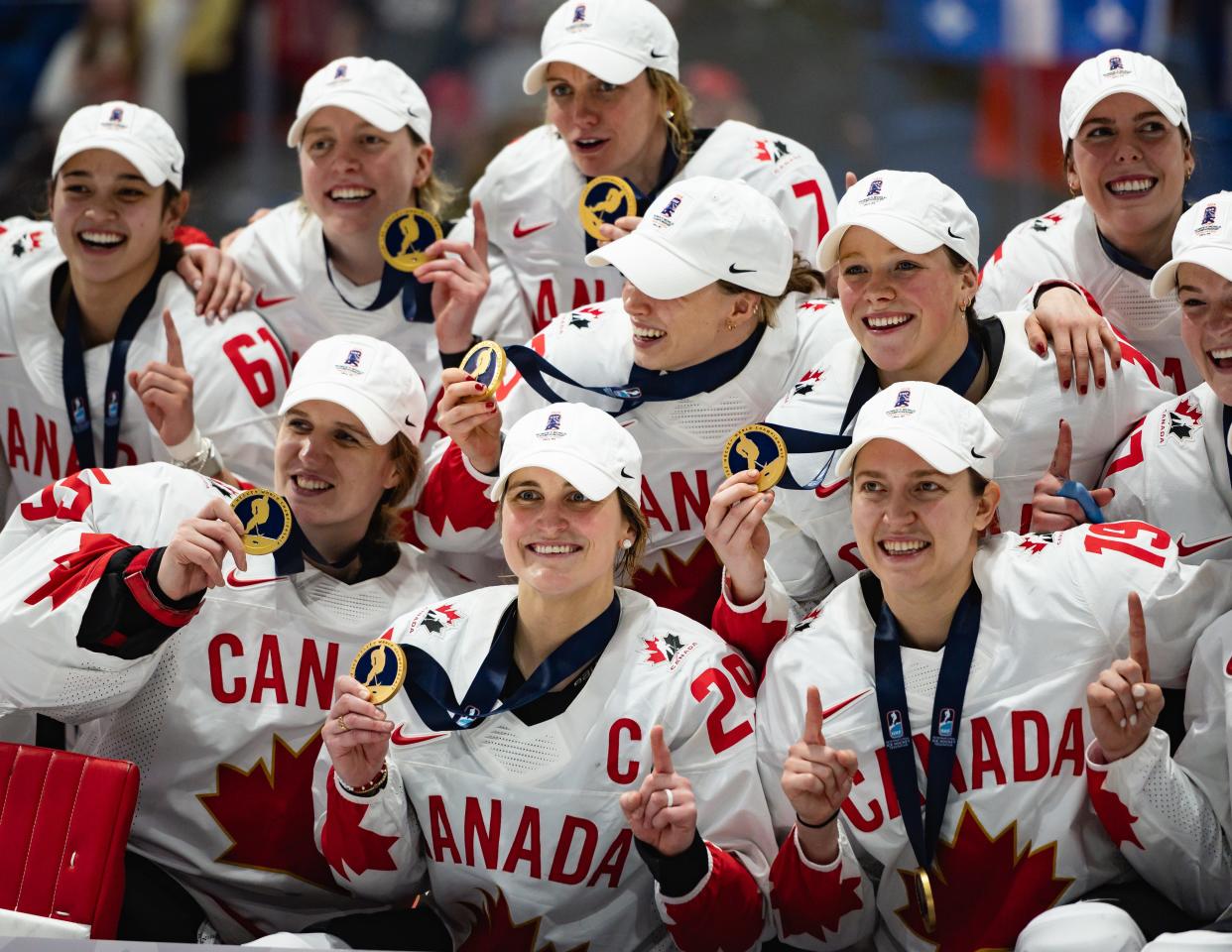 Canadian players celebrate with their gold medals after they defeat the United States in overtime at the Adirondack Bank Center Sunday.