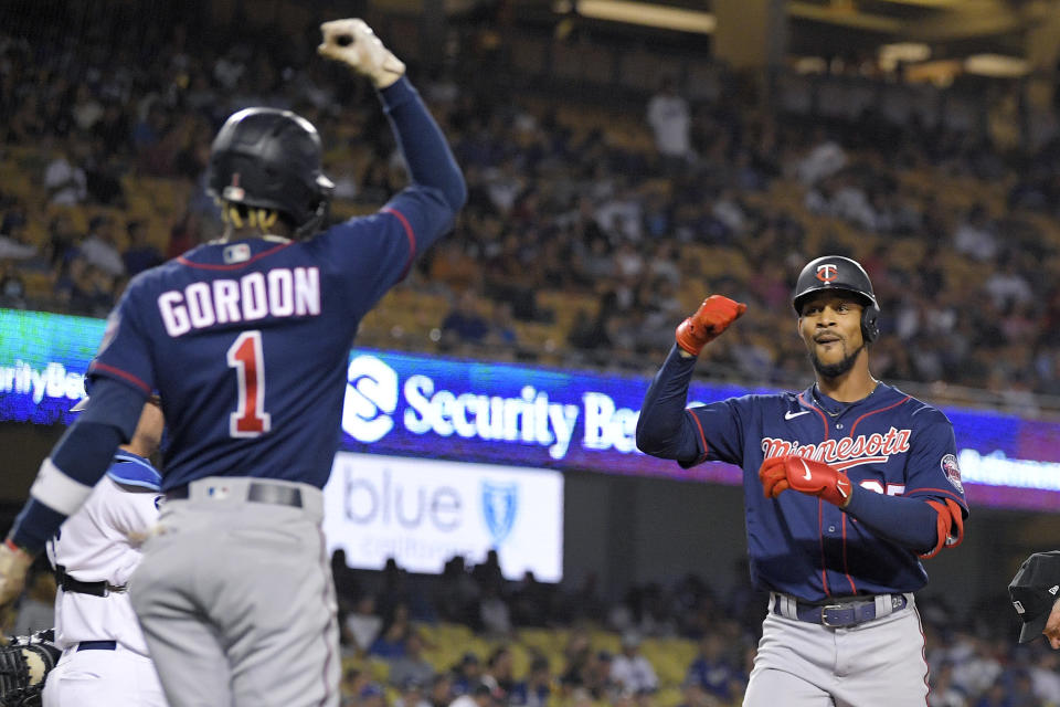 Minnesota Twins' Byron Buxton, right, is congratulated by Nick Gordon after hitting a two-run home run during the eighth inning of a baseball game against the Los Angeles Dodgers Tuesday, Aug. 9, 2022, in Los Angeles. (AP Photo/Mark J. Terrill)