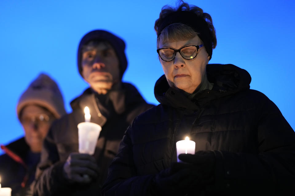 Local residents pray during a candlelight vigil following a shooting at Perry High School, Thursday, Jan. 4, 2024, in Perry, Iowa. (AP Photo/Charlie Neibergall)