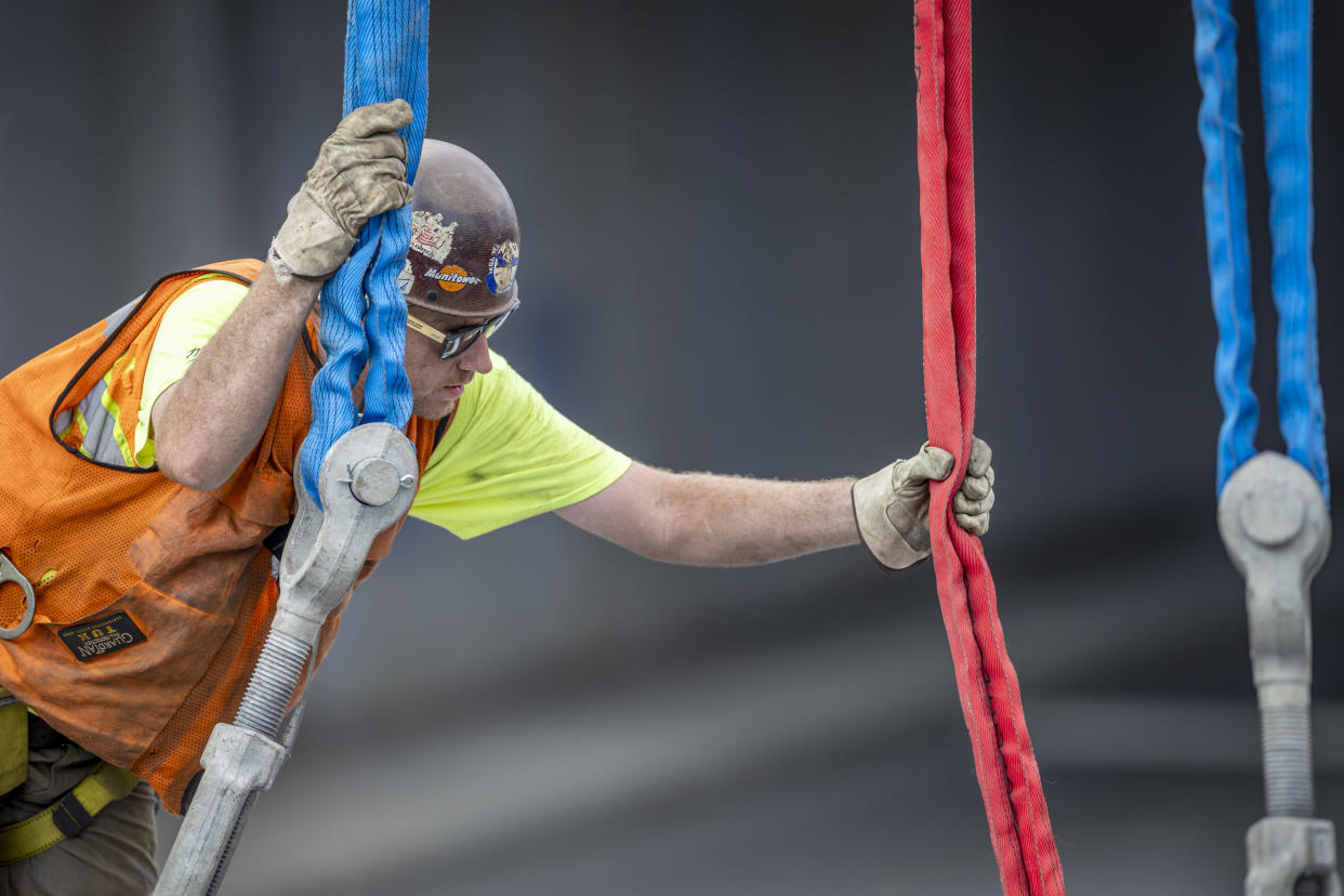 Workers prepare to lift a new pedestrian bridge into place at the Stamford Transportation Center on August 26, 2023 in Stamford, Connecticut. (Photo by John Moore/Getty Images)