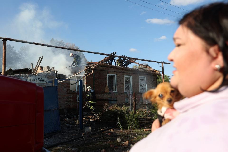 Rescuers extinguish a fire after a house was hit by a missile strike in Bakhmut, Donetsk region on October 8, 2022, amid Russia's invasion of Ukraine. (Photo by Anatolii STEPANOV / AFP) (Photo by ANATOLII STEPANOV/AFP via Getty Images)