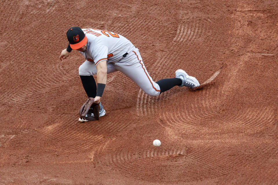 Baltimore Orioles third baseman Ramon Urias commits an error as he fails to field a hit by Boston Red Sox's Trevor Story during the third inning of a baseball game at Fenway Park, Sunday, Sept. 10, 2023, in Boston. (AP Photo/Mary Schwalm)