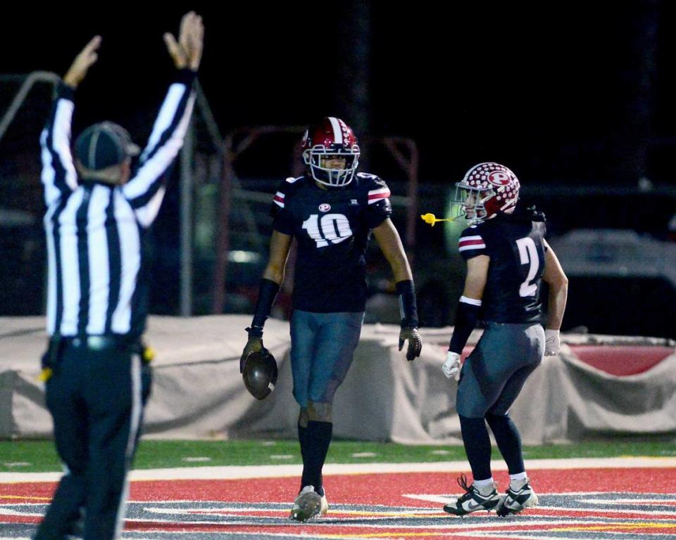 Patterson receiver Frank Callum (10) celebrates scoring a touchdown with teammate Noah Cozart (2) during a Division IV Sac Joaquin Section Football Playoff game between Patterson and Kimball at Patterson High School in Patterson CA on November 10, 2023.
