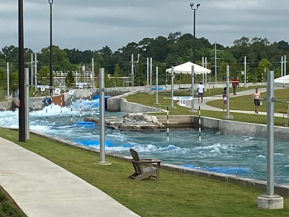 Guests walk next to the river channel Friday morning, July 7. 2023, at Montgomery Whitewater, which is celebrating its grand opening this weekend.