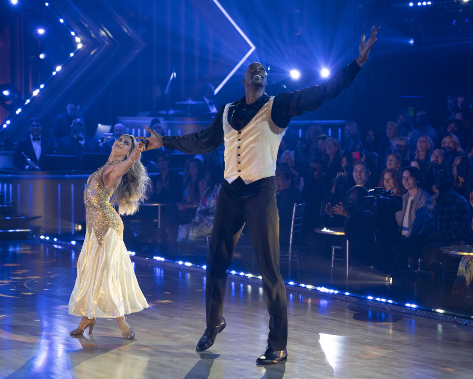 Professional dancer Daniella Karagach (left) and NBA star Dwight Howard dance on stage. 