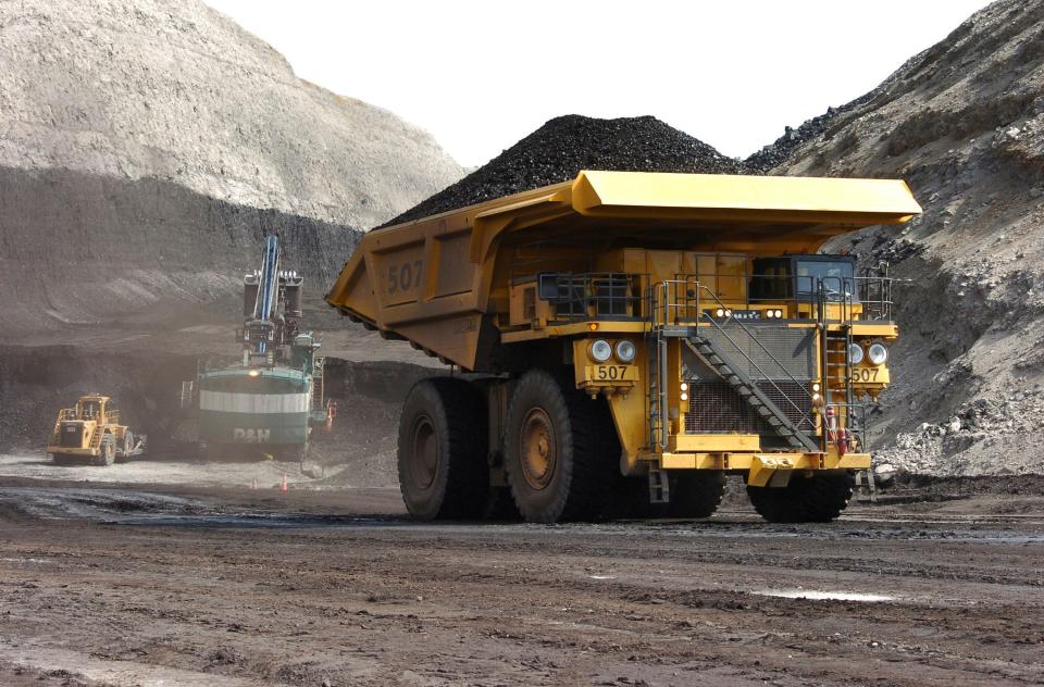 A truck carrying 250 tons of coal hauls the fuel to the surface of the Spring Creek mine near Decker, Mont., in 2013.