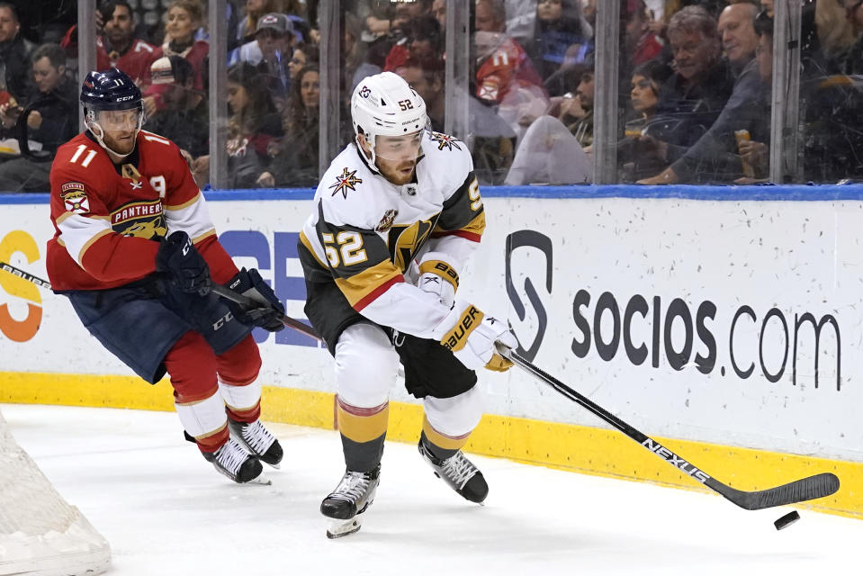 Vegas Golden Knights defenseman Dylan Coghlan (52) skates with the puck as Florida Panthers left wing Jonathan Huberdeau (11) pursues during the second period of an NHL hockey game, Thursday, Jan. 27, 2022, in Sunrise, Fla. (AP Photo/Lynne Sladky)