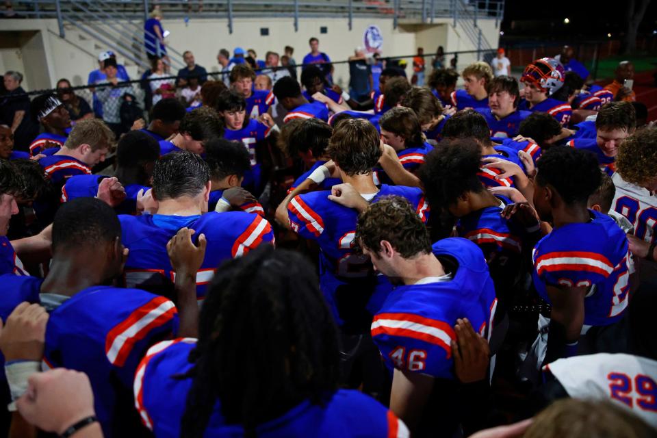 Bolles Bulldogs huddle to recite the Lord's Prayer after a regular season football game Friday, Sept. 2, 2022 at The Bolles School in Jacksonville. The Bolles Bulldogs defeated the Mandarin Mustangs 27-20. 