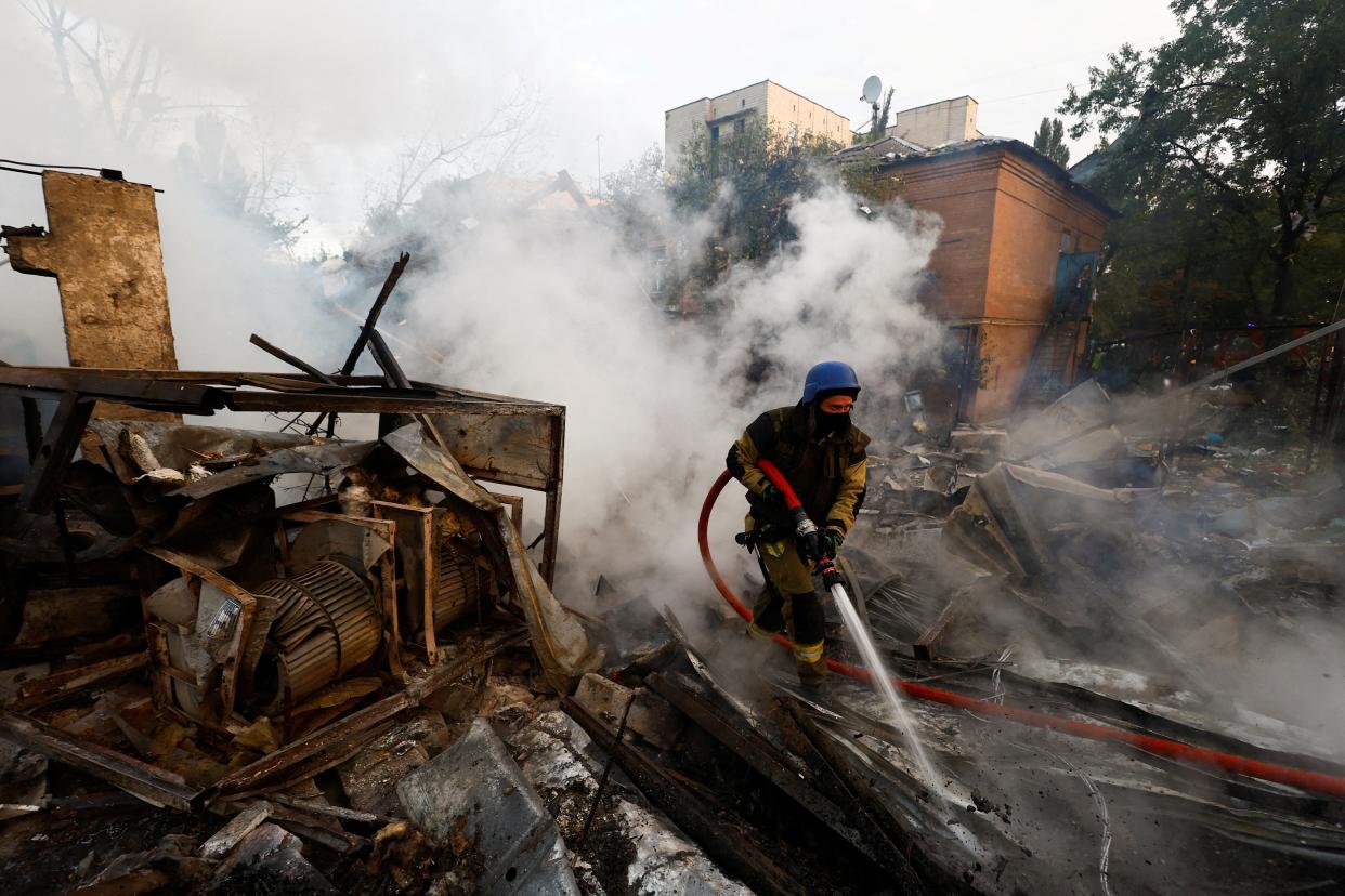 A firefighter works at a site in a residential area damaged during a Russian missile strike (REUTERS)