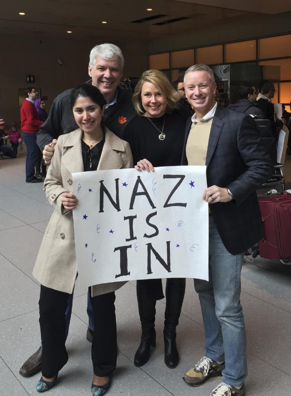 In this photo provided by Eric Martinez, Nazanin Zinouri, front left, and her colleagues from Modjoul, a startup technology firm in Clemson, S.C., pose for a photo after Zinouri arrived at Logan International Airport in Boston on Sunday, Feb. 5, 2017. Zinouri, an Iranian engineer who had been blocked from returning to South Carolina by President Donald Trump's travel ban against seven Muslim nations, returned to the U.S. on Sunday. Modjoul founder Martinez, from left, co-worker Jen Thorson and Rick Toller stand by Zinouri. (courtesy of Eric Martinez via AP)