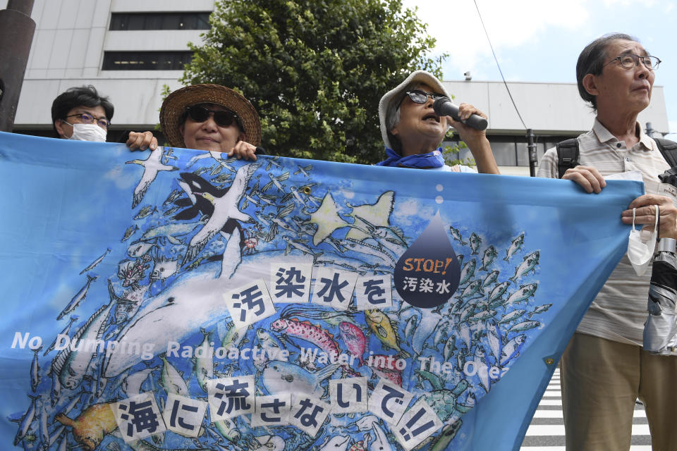 Protesters hold a sign during a rally against the treated radioactive water release from the damaged Fukushima nuclear power plant, in front of Tokyo Electric Power Company Holdings (TEPCO) headquarters, Thursday, Aug. 24, 2023, in Tokyo. The operator of the tsunami-wrecked Fukushima Daiichi nuclear power plant will begin releasing the first batch of treated and diluted radioactive wastewater into the Pacific Ocean later Thursday, utility executives said.(AP Photo/Norihiro Haruta)