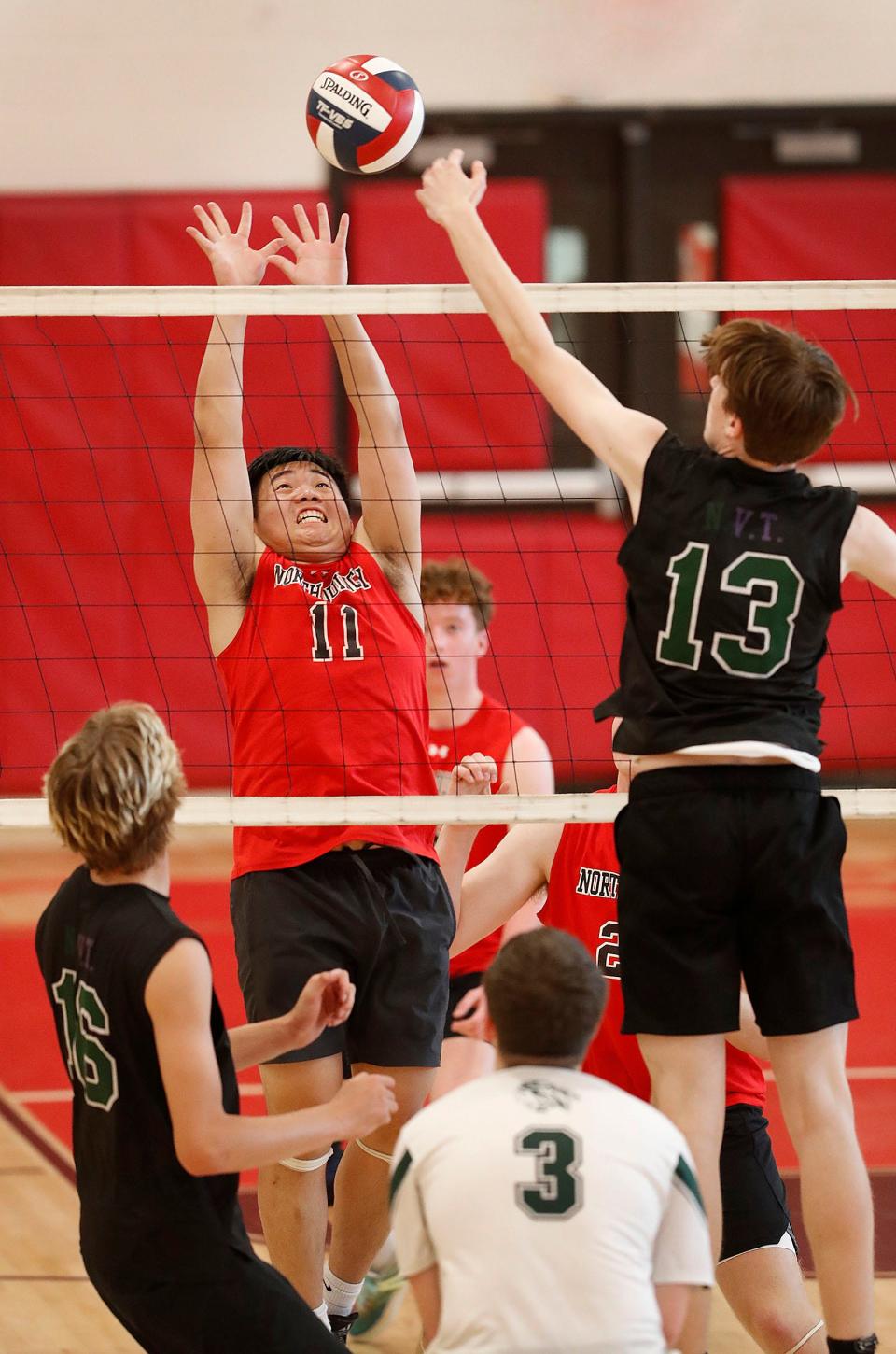 North Quincy's Bobby Lin tries to block a shot at the net by Drew Johnson of Nipmuc on Friday, June 10, 2022.