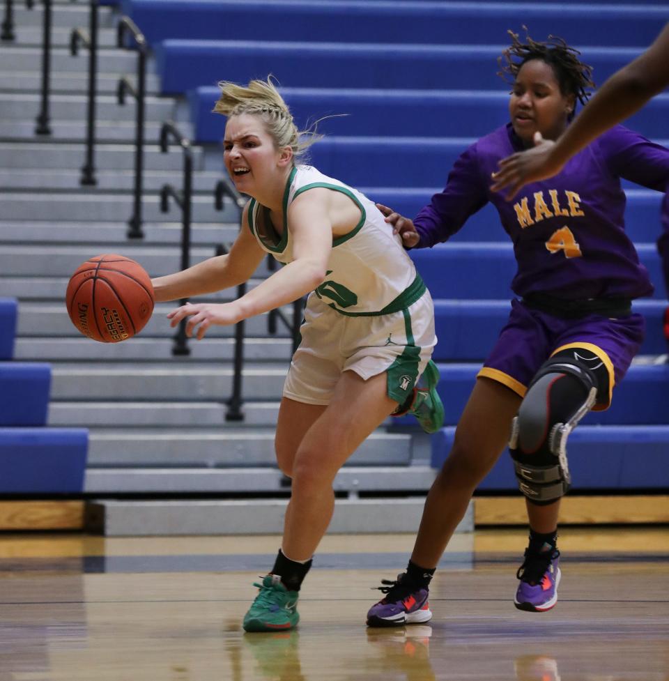 Meade County's Peyton Bradley (20) drives against Male's Kayla Paige (4) during the Girls LIT at the Valley High School gym in Louisville, Ky. on Jan. 24, 2023.