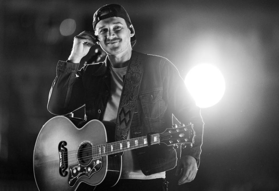 Morgan Wallen onstage with his guitar