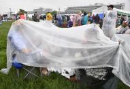 <p>Horse racing fans shelter themselves from the rain during the 144th running of the Kentucky Derby at Churchill Downs in Louisville, Ky., May 5, 2018. (Photo: Jamie Rhodes/USA TODAY Sports/Reuters) </p>