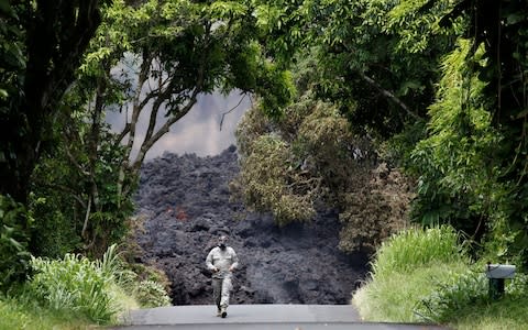 A Hawaii National Guard soldier measures sulfur dioxide gas levels at a lava flow on Highway 137 southeast of Pahoa - Credit: Reuters