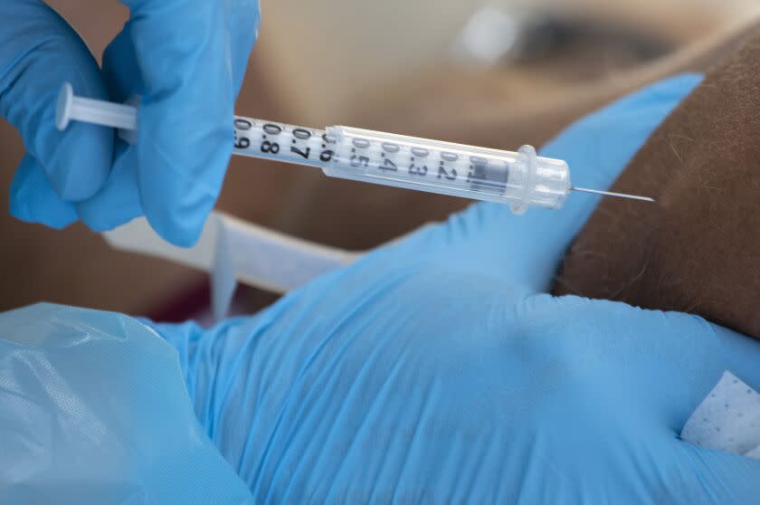 HOLLYWOOD, CA - August 09, 2022- Medical Reserve Corps volunteers administer monkeypox vaccinations at a new walk-up monkeypox vaccination site at Barnsdall Art Park on Tuesday, Aug. 9, 2022 in Hollywood, CA. (Brian van der Brug / Los Angeles Times)