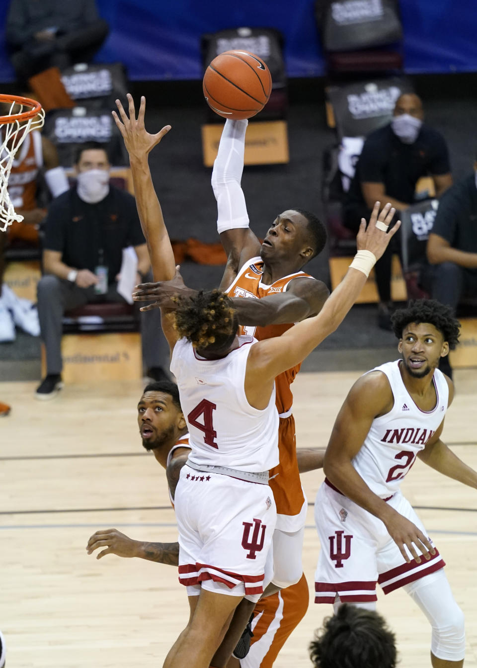 Texas guard Andrew Jones (1) leaps to the basket over Indiana guard Khristian Lander (4) and Indiana forward Jerome Hunter (21) in the second half of an NCAA college basketball game in the semifinals of the Maui Invitational tournament, Tuesday, Dec. 1, 2020, in Asheville, N.C. (AP Photo/Kathy Kmonicek)