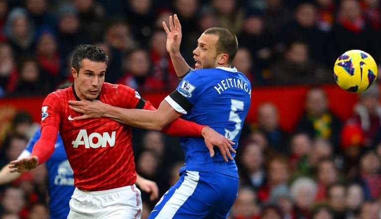 Everton's Dutch defender John Heitinga (R) tangles with Manchester United's Dutch striker Robin van Persie (L) during the English Premier League football match between Manchester United and Everton at Old Trafford, Manchester, North West England, on February 10, 2013. United won 2-0