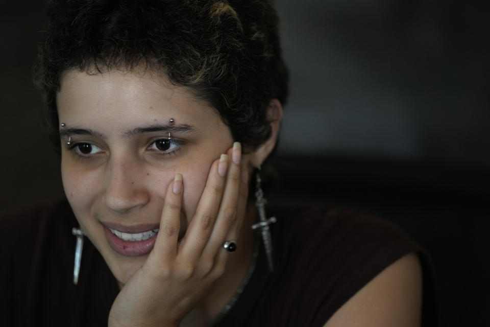 Anthropology major Gaby Batista, 19, works as a student ambassador at New College of Florida's Admissions Welcome Center, Wednesday, March 1, 2023, in Sarasota, Fla. Batista, who identifies as pansexual, non-binary, and uses they/them pronouns, says of high school, "I was bullied for being different." At New College, Batista says, "We have this culture of radical acceptance, I would say. That leads to a lot of living authentically." (AP Photo/Rebecca Blackwell)