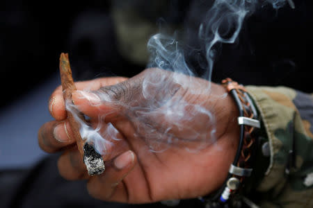 People smoke marijuana on the informal cannabis holiday, 4/20, corresponding to the numerical figure widely recognized within the cannabis subculture as a symbol for all things marijuana, on the Common in Boston, Massachusetts, U.S., April 20, 2017. REUTERS/Brian Snyder