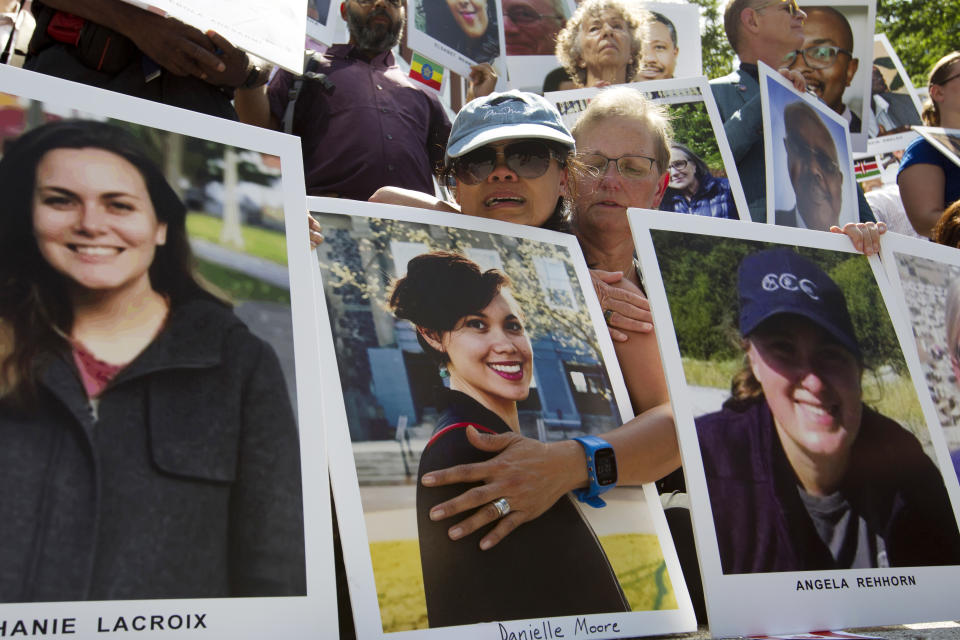 Clariss Moore, left, mother of Danielle and Joana Vincent mother of Angela Rehhorn, cry as they hold the pictures of their daughters during a vigil on the six-month anniversary of the crash of a Boeing 737 Max 8, killing 157 people, in Ethiopia on March 10, which has resulted in the grounding of hundreds of the planes worldwide, outside of the Department of Transportation, Tuesday, Sept. 10, 2019 in Washington. (AP Photo/Jose Luis Magana)