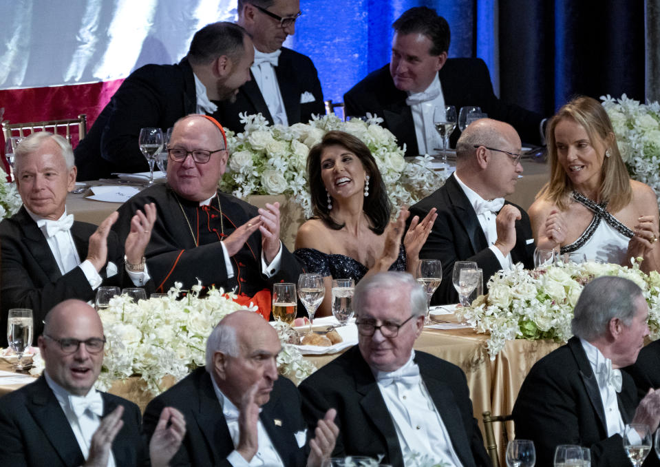 Keynote speaker Ambassador to the United Nations Nikki Haley, center, shares a light moment as she attends the 73rd Annual Alfred E. Smith Memorial Foundation Dinner Thursday, Oct. 18, 2018, in New York. Left center is Archbishop of New York Cardinal Timothy Dolan, and right center is Michael Haley, husband of Nikki Haley. (AP Photo/Craig Ruttle)