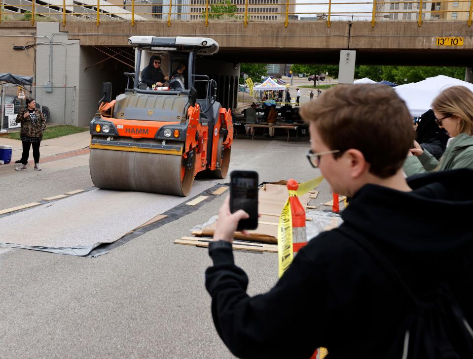 People watch steamroller printing during the sixth annual Steamroller Print Festival at ARTSPACE at Untitled, in Oklahoma City on April 22, 2023.