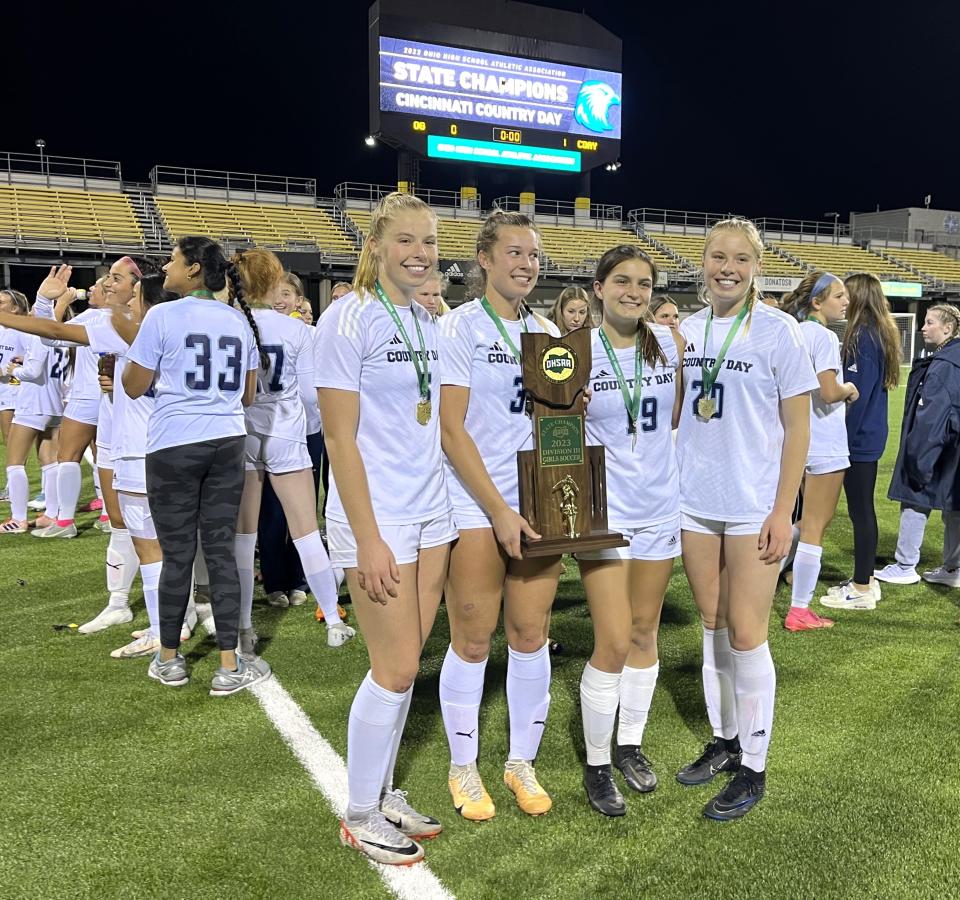 CCD seniors, from left, Megan Zimmerman, Piper Farris, Sydney Hardesty, Elizabeth Zimmerman with the trophy as Cincinnati Country Day defeated Ottawa-Glandorf 1-0 in the OHSAA Division III girls soccer state championship game Nov. 10, 2023 at Historic Crew Stadium, Columbus, Ohio.