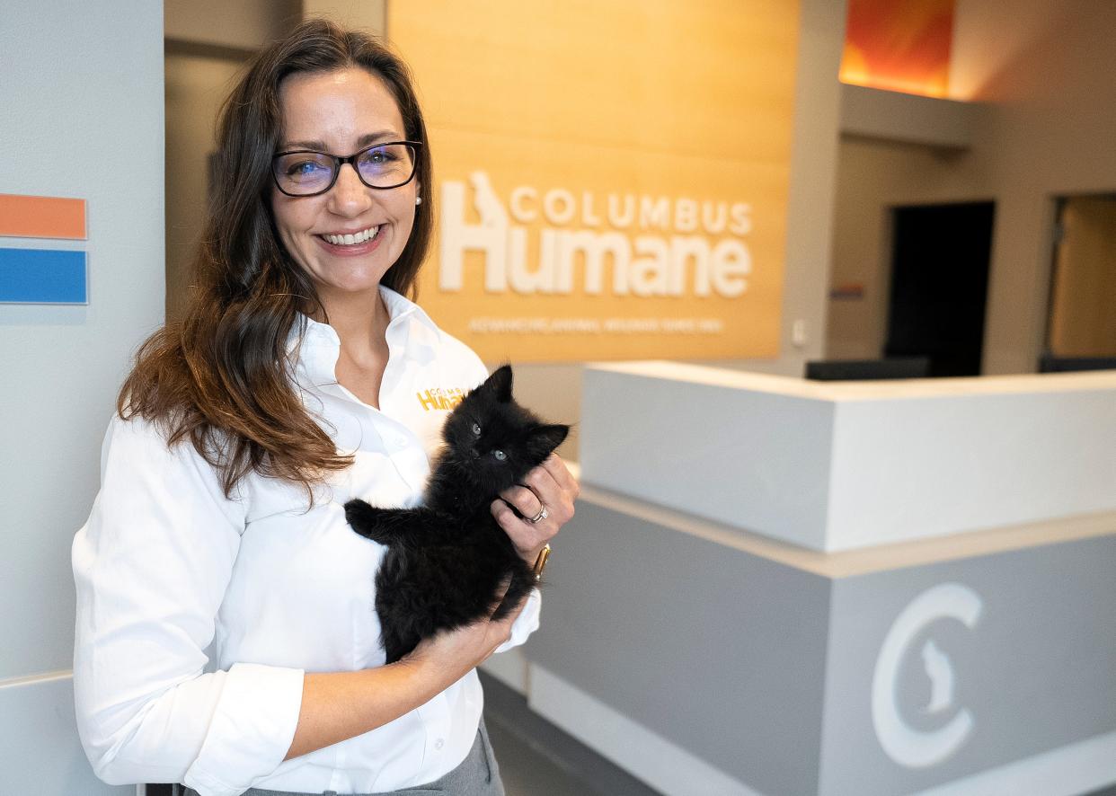 Columbus Humane CEO Rachel D.K. Finney stands in the lobby of the new Essential Care Center, holding a kitten named Big Al, on Thursday. The center is the first-ever comprehensive facility for underserved pets in the United States.