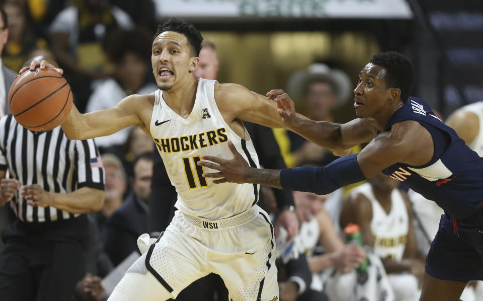 Wichita State guard Landry Shamet (11) steals the ball and is fouled by Connecticut guard Christian Vital during the first half of an NCAA college basketball game Saturday, Feb. 10, 2018, in Wichita, Kan. (Travis Heying/The Wichita Eagle via AP)