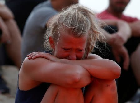 FILE PHOTO: A crew member of charity ship MV Lifeline reacts during a vigil to commemorate migrants who have lost their lives whilst crossing the Mediterranean, in Valletta's Marsamxett Harbour, Malta July 5, 2018. REUTERS/Darrin Zammit Lupi/File Photo