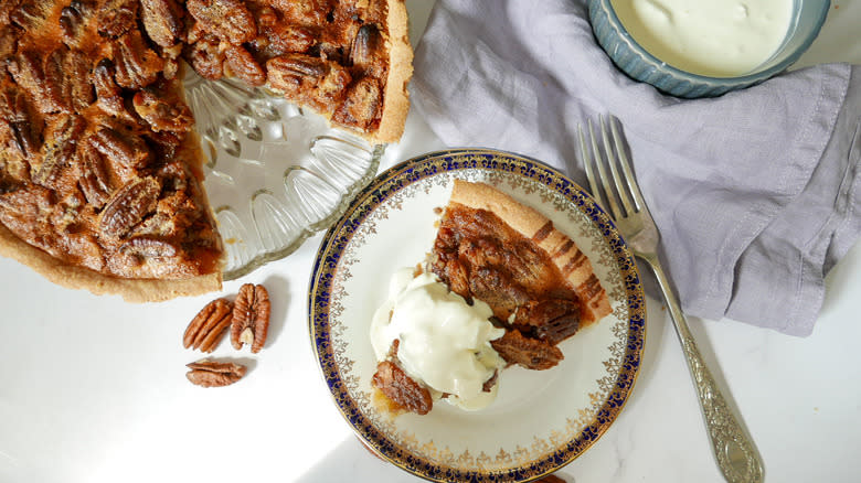 slice pecan pie with cream