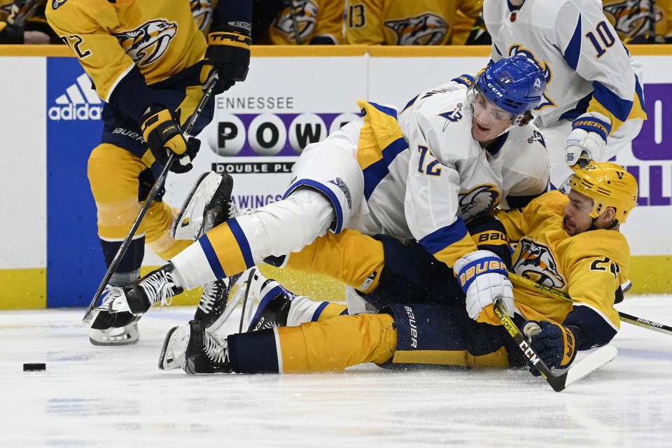 Buffalo Sabres center Tage Thompson (72) falls on Nashville Predators right wing Nino Niederreiter (22) as they chase the puck during the second period of an NHL hockey game Saturday, Jan. 14, 2023, in Nashville, Tenn. (AP Photo/Mark Zaleski)