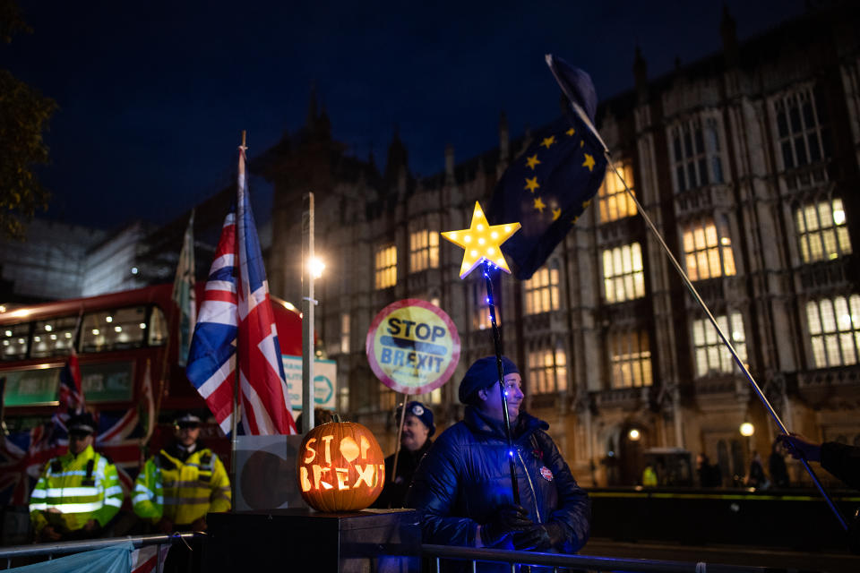 LONDON, ENGLAND - OCTOBER 29: Anti-Brexit activists stand with a "Stop Brexit" halloween pumpkin outside the Houses of Parliament on October 29, 2019 in London, England. Later today, Prime Minister Boris Johnson will put forward a motion for a short bill proposing an early general election, which Labour Party leader Jeremy Corbyn says his party will support.  (Photo by Leon Neal/Getty Images)