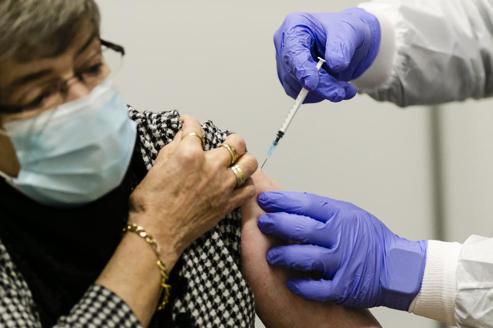 81-year-old Ursula Claassen receives a new coronavirus vaccination in Kiel, Germany, Monday, Jan. 4, 2021. On Monday vaccinations against the coronavirus have started in the German state of Schleswig-Holstein. (Frank Molter/dpa via AP)