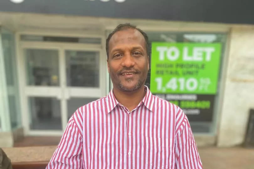 Khalid Elhaj sitting on a bench in Warrington town centre