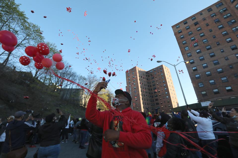 Balloons are released during a a vigil for DMX where he grew up, on School Street in Yonkers April 13, 2021.