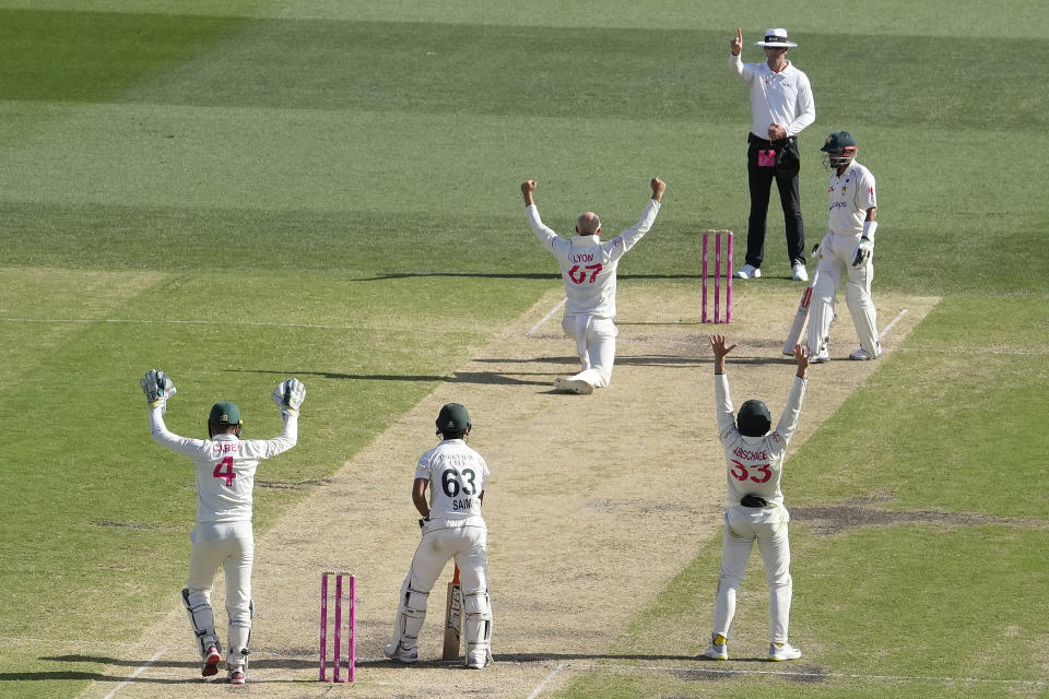Australia's Nathan Lyon, center, appeals for and is awarded the LBW decision on Pakistan's Saim Ayub on the third day of their cricket test match in Sydney, Friday, Jan. 5, 2024. (AP Photo/Rick Rycroft)