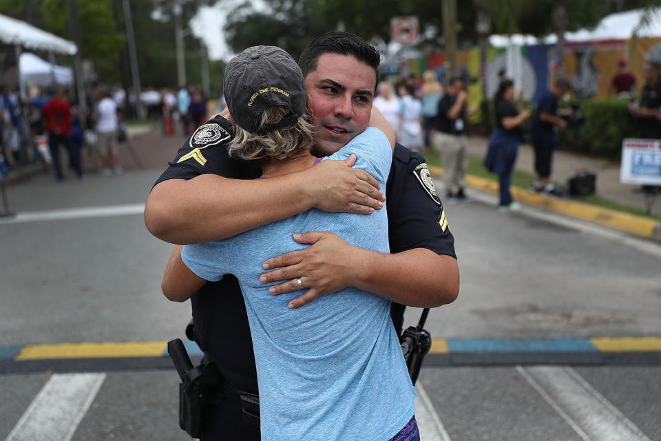 <p>University Of Central Florida Police officer Pablo Vargas receives a hug from Christine Gigicos as they attend the one-year anniversary memorial service for victims of the mass shooting at the Pulse gay nightclub on June 12, 2017 in Orlando, Florida. (Joe Raedle/Getty Images) </p>