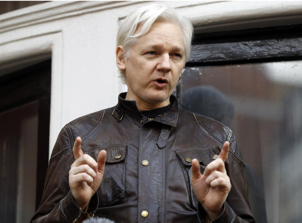 FILE - In this May 19, 2017, file photo, WikiLeaks founder Julian Assange gestures to supporters outside the Ecuadorian embassy in London, where he has been in self imposed exile since 2012. (AP Photo/Frank Augstein, File)