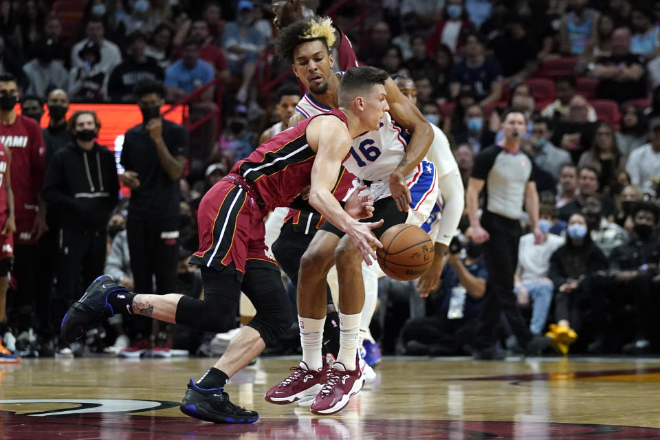 Miami Heat guard Tyler Herro, left, drives to the basket as Philadelphia 76ers guard Charlie Brown Jr. (16) defends during the first half of an NBA basketball game, Saturday, Jan. 15, 2022, in Miami. (AP Photo/Lynne Sladky)