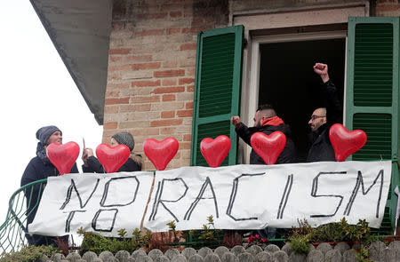 Demonstrators stand on a balcony during an anti-racism rally in Macerata, Italy, February 10, 2018. REUTERS/Yara Nardi