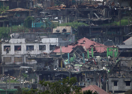 Damaged buildings and houses are seen as government troops continue their assault on its 105th day of clearing operations against pro-IS militants who have seized control of large parts of Marawi city, southern Philippines September 4, 2017. REUTERS/Romeo Ranoco