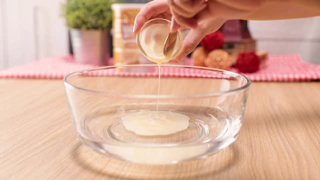 Pouring condensed milk into water in a mixing bowl