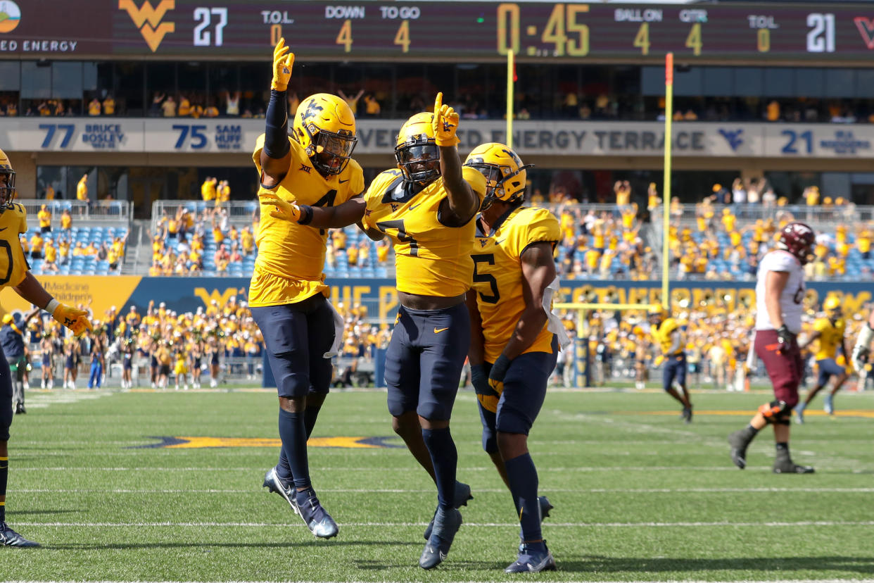 West Virginia Mountaineers safety Alonzo Addae (4), cornerback Jackie Matthews (3) and linebacker Lance Dixon (5) celebrate after Matthews sealed the Mountaineers' victory. (Frank Jansky/Icon Sportswire via Getty Images)