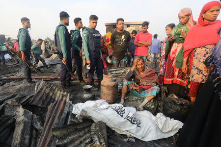 A man who lost his wife in a fire cries in Chittagong, Bangladesh February 17, 2019. REUTERS/Stringer