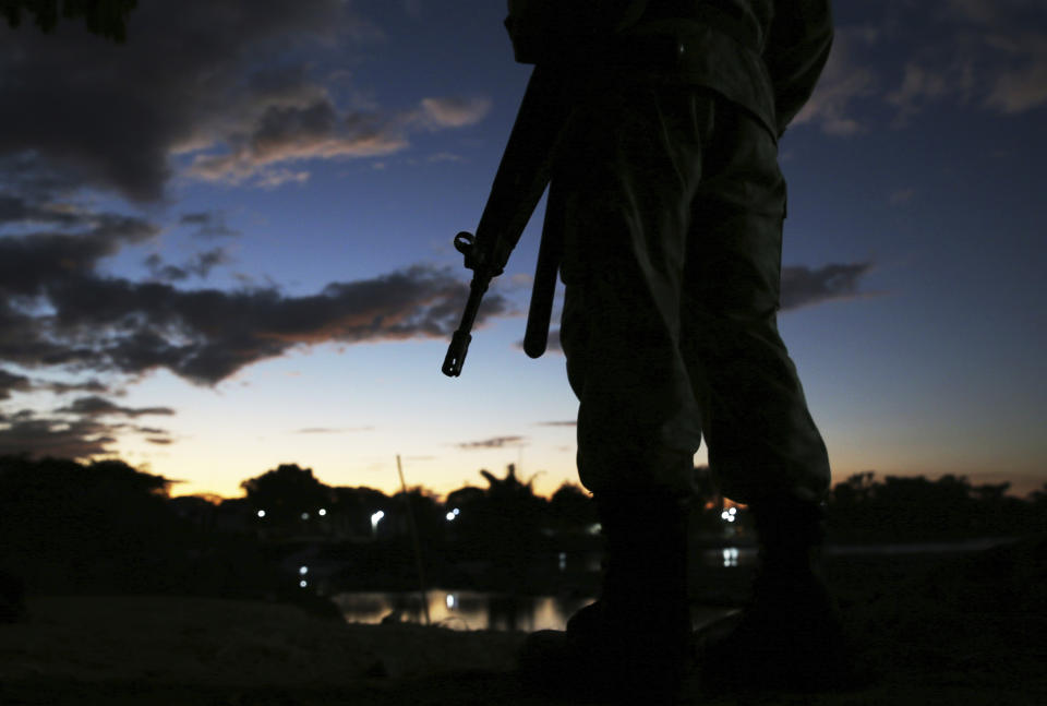 A Mexican National Guard patrols near the bridge that crosses the Suchiate River, on the border with Guatemala, near Ciudad Hidalgo, Mexico, Friday, Jan. 17, 2020. United States officials are crediting tough measures taken over the past year and cooperation from regional governments for sharply reducing the number of Central American migrants who responded to a call for a new caravan. (AP Photo/Marco Ugarte)