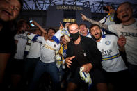 Leeds United fans celebrate outside Elland Road after Huddersfield Town beat West Bromwich Albion to seal their promotion to the Premier League.